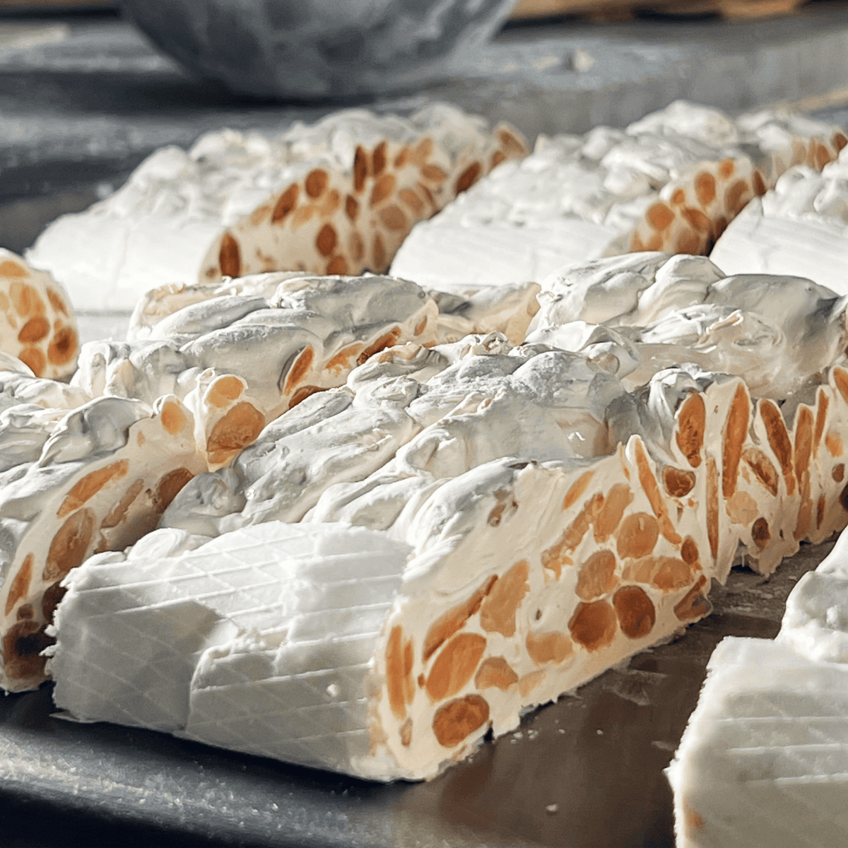 Blocchi di Torrone Classico alla Mandorla appena tagliati nel laboratorio del Torronificio del Casale
